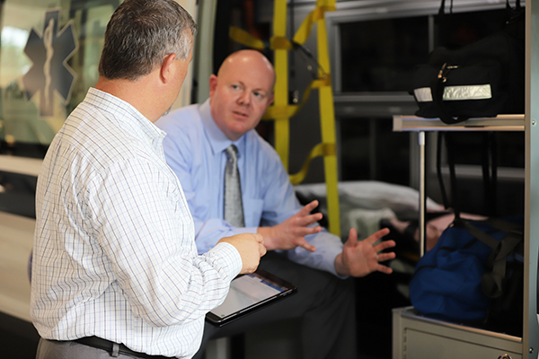 Glatfelter team working with a commercial ambulance client standing beside an ambulance
